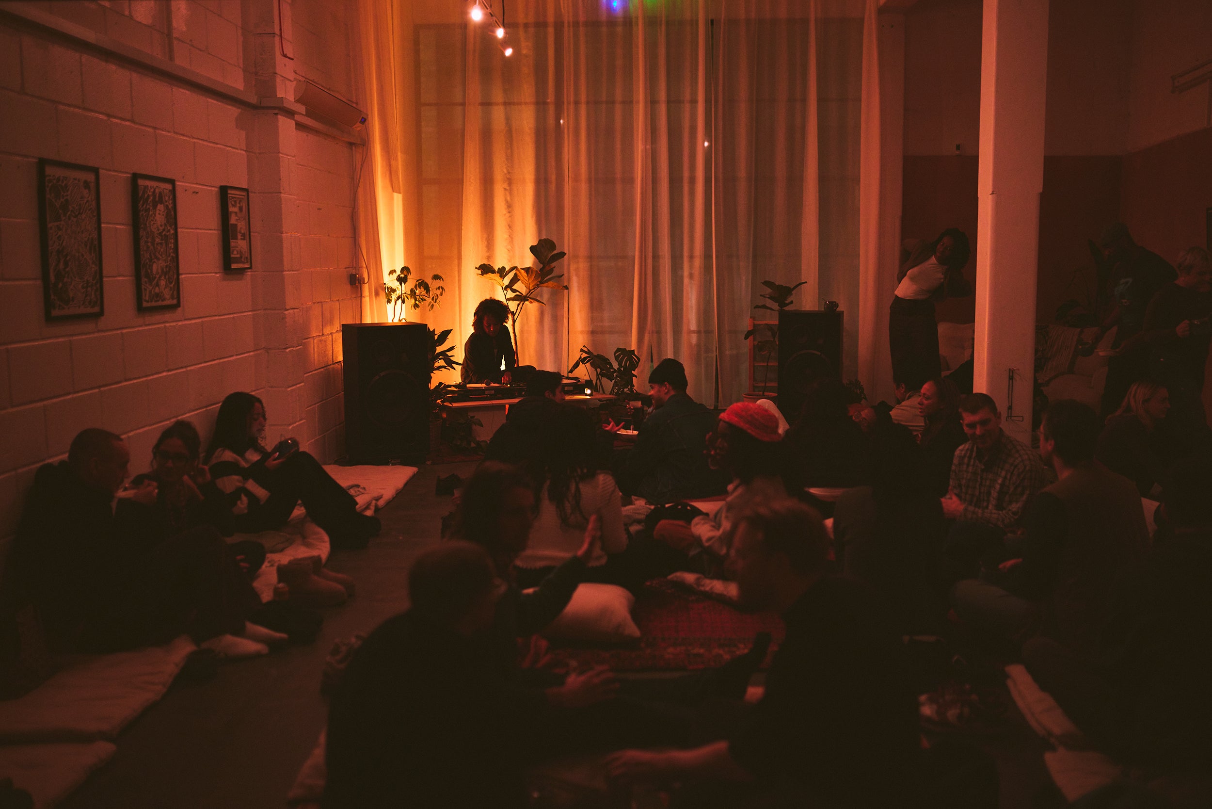 Intimate listening session at Shai Space with guests seated on floor mats
